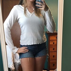 white notch necked long sleeve with ruffle edges